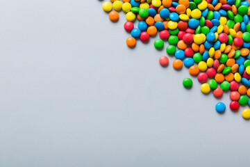 Mixed collection of colorful candy, on colored background. Flat lay, top view. frame of colorful chocolate coated candy