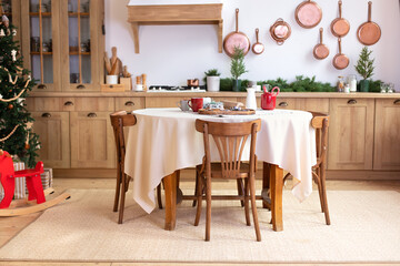 Stylish dining room in rustic style. Cozy kitchen decorated Christmas or new year. horse rocking chair. Mid Century design room. Interior design scandinavian wooden kitchen with round table and chairs
