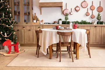 Stylish dining room in rustic style. Cozy kitchen decorated Christmas or new year. horse rocking chair. Mid Century design room. Interior design scandinavian wooden kitchen with round table and chairs