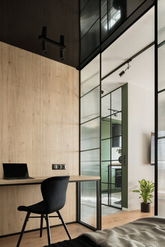 Modern home office in room with reinforced glass wall