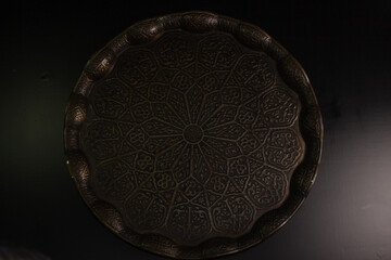 A bronze tray with geometric figures in the traditional execution of oriental culture