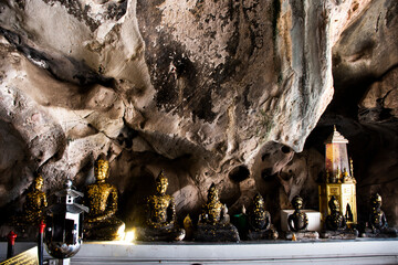Carving stone and sculpture buddha image statue on cave wall of Tham Khao Ngu for thai people...