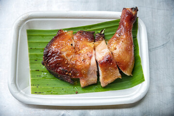 Close up of grilled chicken on plate.