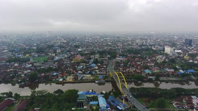 February 5, 2022. Above Pekanbaru, Riau, Indonesia. Leighton Bridge or Siak Bridge above the Siak River. Aerial footage.