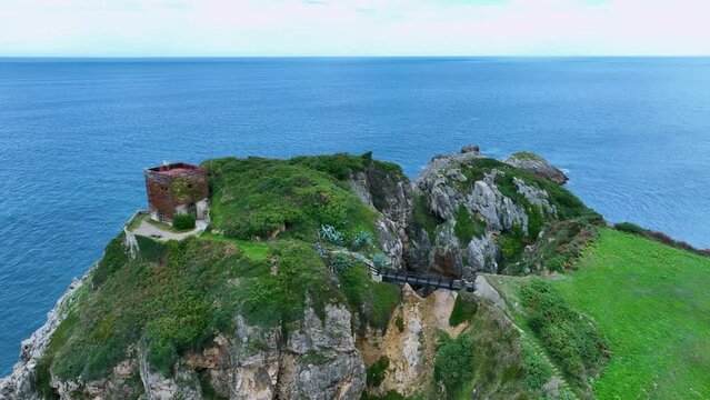 Landscape of cliffs and mowing meadows on the Am&iacute;o Coast. Aerial view from a drone. Pechon town. Cantabria. Spain. Europe.