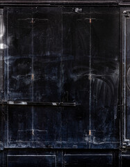 Black wooden door textured background.