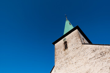 White facade and turquoise roof of an old church in Arnsberg Sauerland Germany. Green oxidated and...