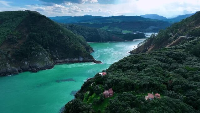 Landscape of cliffs and mowing meadows on the Am&iacute;o Coast. Aerial view from a drone. Pechon town. Cantabria. Spain. Europe.