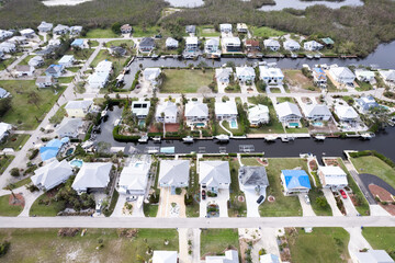 Hurricane Ian destroyed homes in Florida residential area on golf course. Natural disaster and its...
