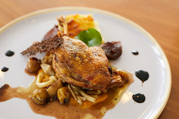 Roasted duck leg in prune sauce