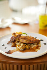 Roasted duck leg in prune sauce