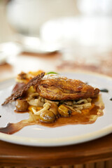 Roasted duck leg in prune sauce