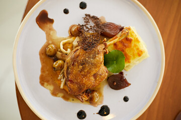 Roasted duck leg in prune sauce