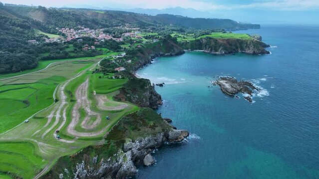 Landscape of cliffs and mowing meadows on the Am&iacute;o Coast. Aerial view from a drone. Pechon town. Cantabria. Spain. Europe.