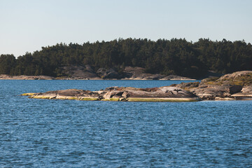 Fototapeta premium Archipelago National Park landscape, Southwest Finland, with islands, islets and skerries, Saaristomeren kansallispuisto, summer sunny day, view from shuttle ship ferry boat in the Archipelago Sea