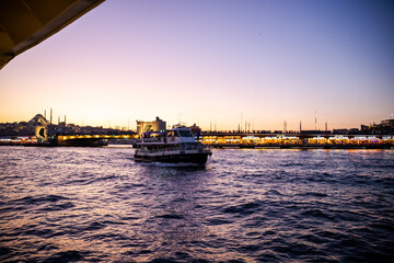 Fototapeta premium sunset in istanbul, galata bridge looks great at sunset. passenger ship