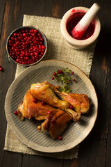 Fried chicken with delicious juicy lingonberry sauce on a plate, top view