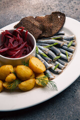 Sprat with beetroot salad and baked potatoes