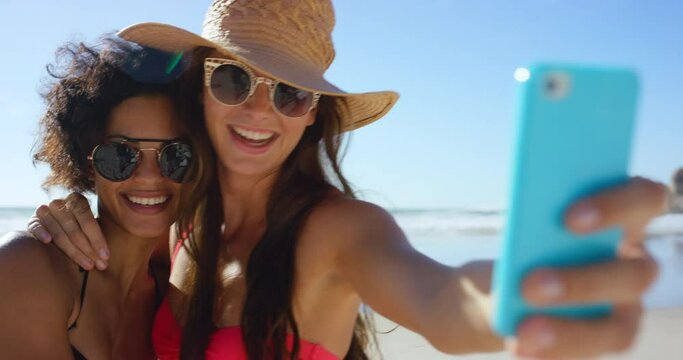 Woman, friends and smile for beach selfie, travel or summer vacation together in the outdoors. Happy women relaxing and smiling in happiness for traveling friendship posing for photo on smartphone