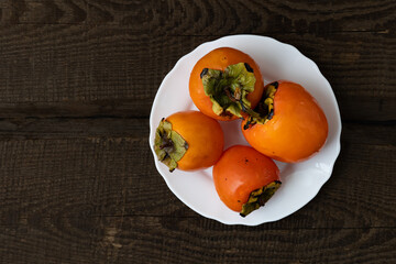 Persimmon on a plate. Top view.