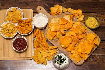 Tortilla chips on a cutting board and dipping sauce