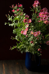 A bouquet of beautiful pink chrysanthemums in a vintage vase