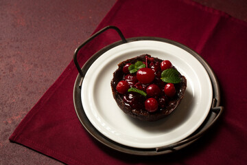 Chocolate dessert with cherries and mint