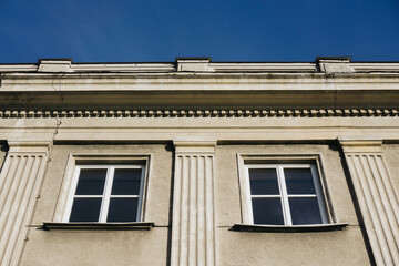 Fototapeta na wymiar Architecture background. Two windows building. Pillar style design.