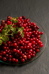 lingonberry berries on a black stone board