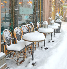Snowfall and blizzard in Helsinki. Snow-covered tables of street cafe in Pohjoisesplanadi street in...