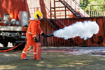 Fireman wearing fire protection suite and oxygen tank exercise hold extinguisher tank and pray