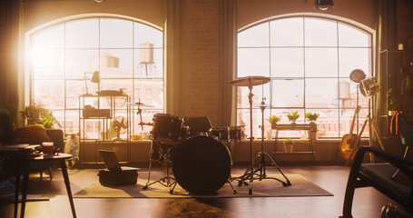 Establishing Shot: Music Rehearsal Studio in Loft Room with Drum Set in the Middle. Stylish...