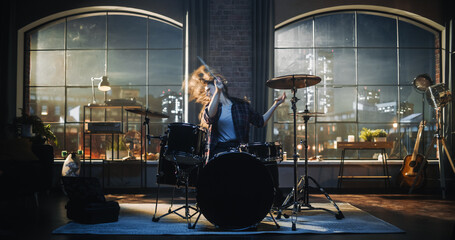 Beautiful Young Drummer Playing at a Band Rehearsal, Doing Tricks with Drumsticks. Learning Drum Solo on Drums and Cymbals in Evening Living Room Loft Apartment. - obrazy, fototapety, plakaty