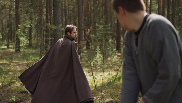 sword fight with knight in forest, reconstruction of battles, duel