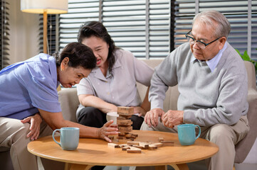 Group of elderly people enjoy talking , relaxing with game at  senior healthcare center.