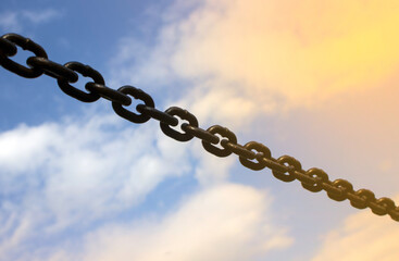 Stretched metal chain against the background of the sky