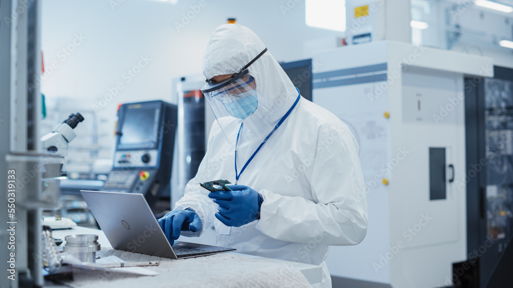 Aufkleber modern technology concept: engineer in coverall working on laptop computer, examining a circuit boar