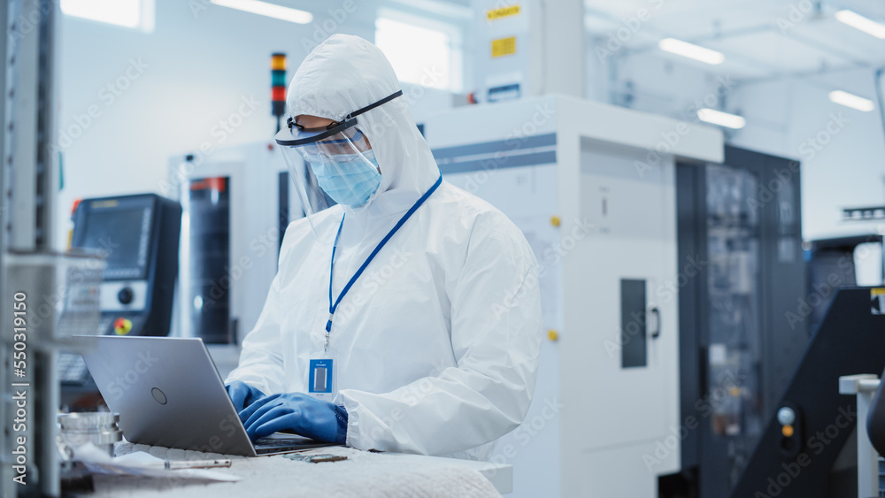 Aufkleber modern technology concept: engineer in coverall working on laptop computer, examining a circuit boar