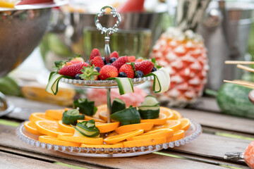 high-grade glassware with fresh fruit, double bowl with fresh fruit,  double bowl with strawberries and orange, sweet door - obrazy, fototapety, plakaty