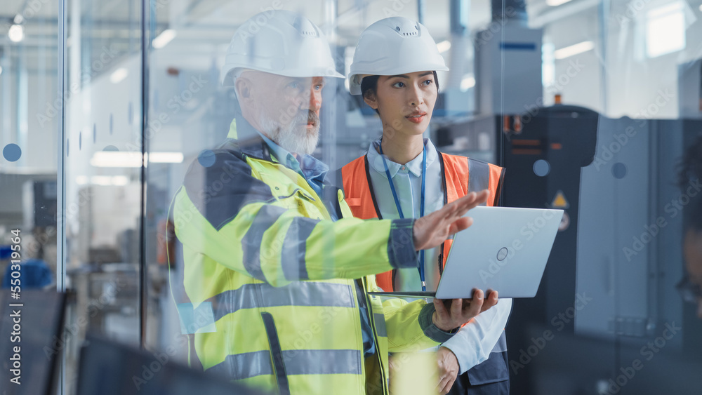 Poster asian quality control specialist conducting an industrial facility check with the help of middle age