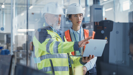 Asian Quality Control Specialist Conducting an Industrial Facility Check with the Help of Middle...