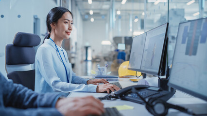 Factory Office Room: Industrial Engineers Developing Models of a Heavy Industry Machine Parts on a Computer 3D Software. Modern Technological Industry 4.0 Research and Development Center.