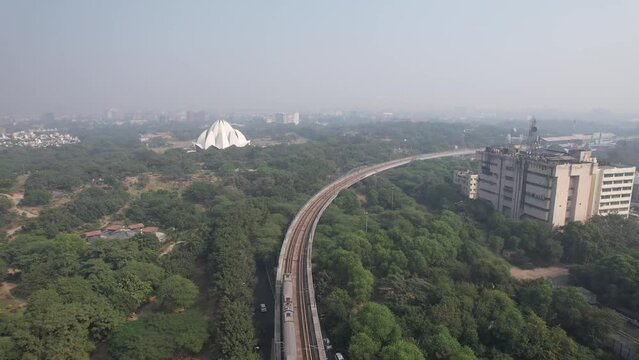 Aerial Drone shot of Delhi metro train and Lotus Temple Kalkaji Metro Station in New Delhi India