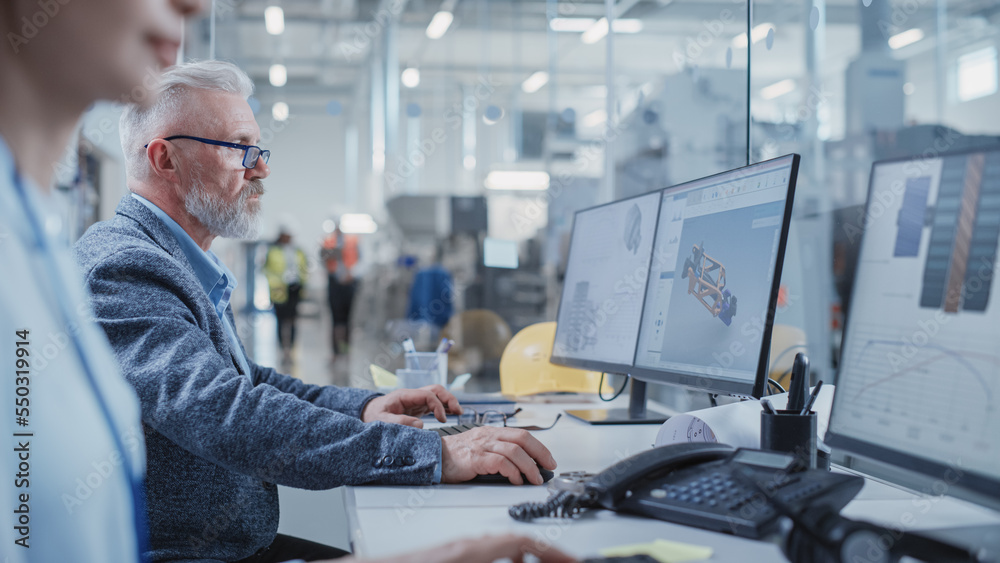 Poster Portrait of a Middle Aged Industrial Engineer Developing Models of a Heavy Industry Machine Parts on Computer 3D Software in a Factory. Modern Technological Research and Development Center.