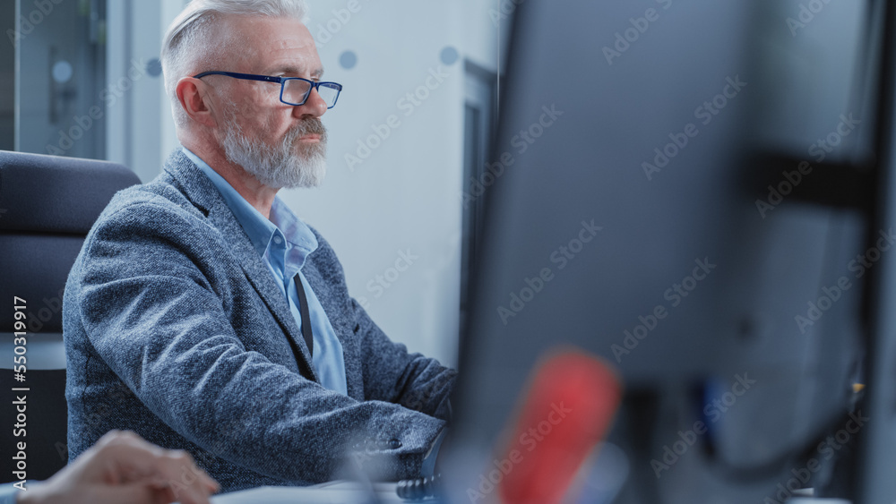 Poster Portrait of a Middle Aged Industrial Engineer Developing Models of a Heavy Industry Machine Parts on Computer 3D Software in a Factory. Modern Technological Research and Development Center.