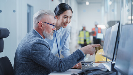 Factory Office Design Agency: Industrial Engineers Discussing 3D Layouts of a Heavy Industry Hydraulic Machine Parts on a Computer CAD Software. Modern Technological Research and Development Center.