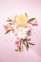 Delicate flower arrangement with flowers and leaves. Summer festive background. Copy space, flat lay.