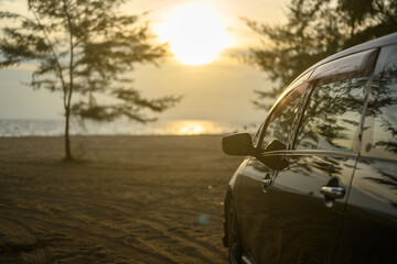 Obraz na płótnie Canvas travel road trip. Car and sunset road trip travel at beach