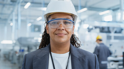 Close Up Portrait of a Successful, Happy and Smiling African Female Engineer in White Hard Hat...