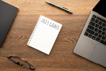 Notebook with 2023 goals text on it to apply new year resolutions and plan.